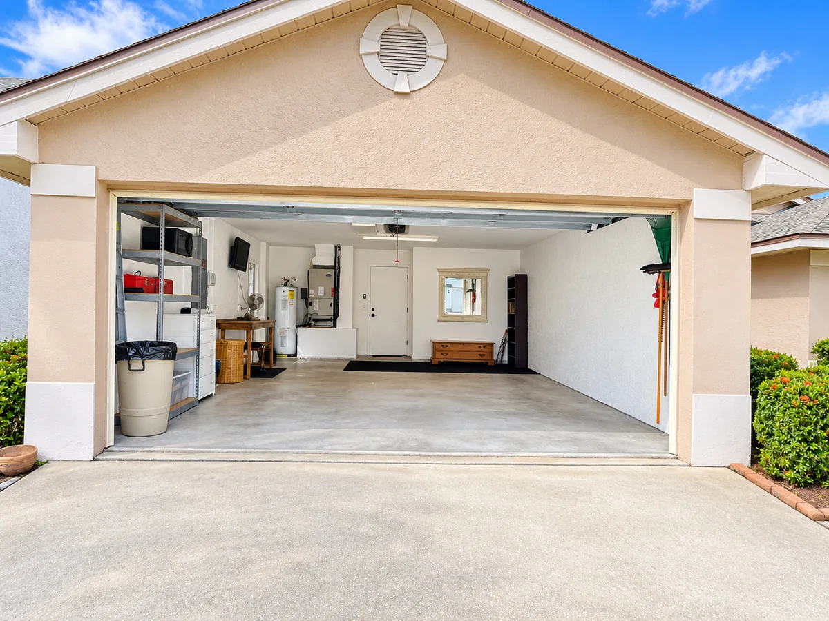 Center view of the two-car garage with open floor space and shelving