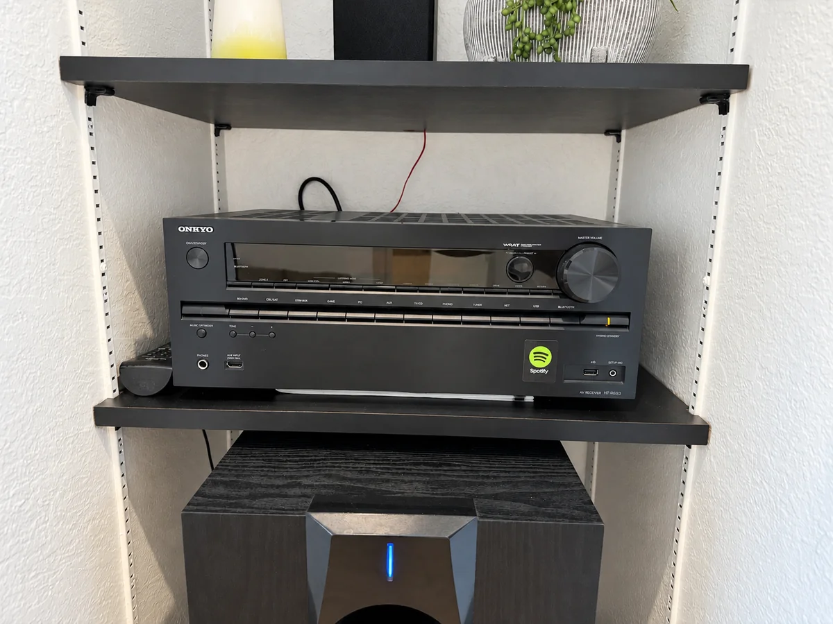 Surround-sound receiver and speaker equipment on built-in shelving