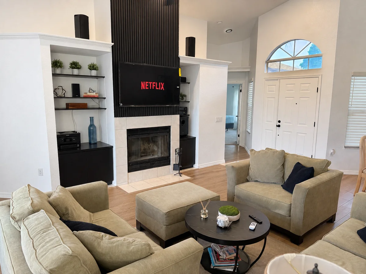 Living room television and speakers facing upholstered seating
